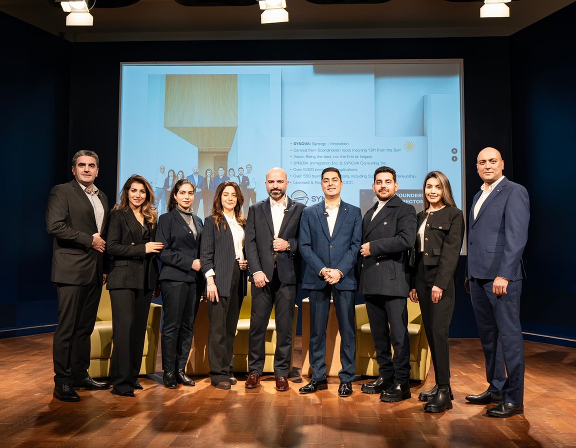 The Synova team on stage at a company event